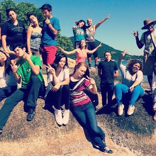 College students posing on a rock